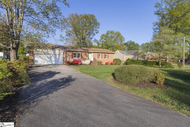 309 Frank St, Easley, SC 29642 - ranch-style home with aphalt driveway, a garage, and a front lawn
