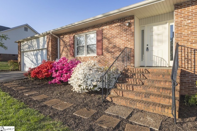 309 Frank St, Easley, SC 29642 - entrance to property featuring an attached garage, driveway, and brick siding