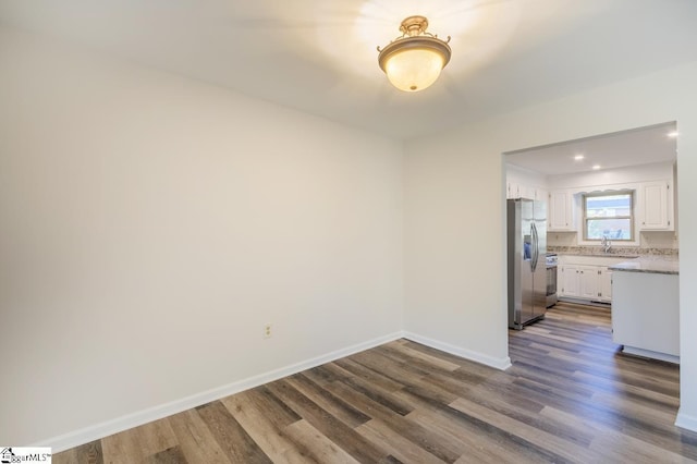 309 Frank St, Easley, SC 29642 - unfurnished dining area with dark wood-style flooring, baseboards, and a sink