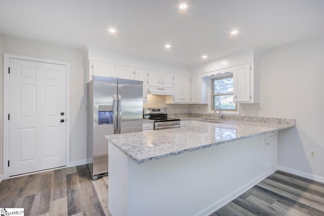 309 Frank St, Easley, SC 29642 - kitchen with a peninsula, wood finished floors, light stone counters, and stainless steel appliances