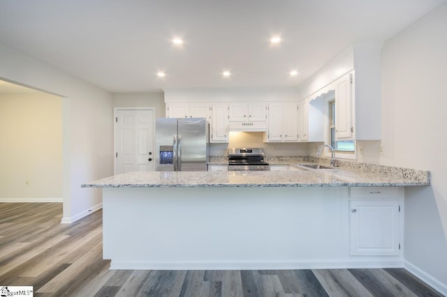 309 Frank St, Easley, SC 29642 - kitchen featuring a peninsula, appliances with stainless steel finishes, a sink, and light stone counters
