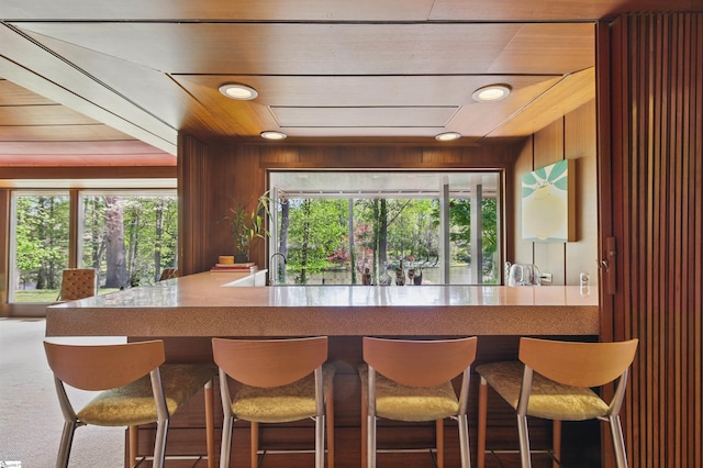 bar featuring wood ceiling, wooden walls, and recessed lighting