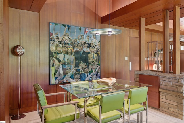 dining area featuring wood walls