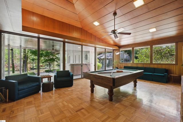 recreation room featuring wood walls, pool table, a healthy amount of sunlight, and ceiling fan