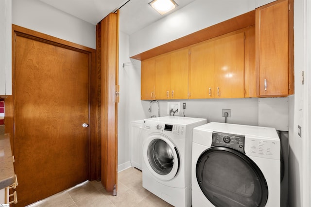 washroom with separate washer and dryer, a sink, light tile patterned flooring, and cabinet space