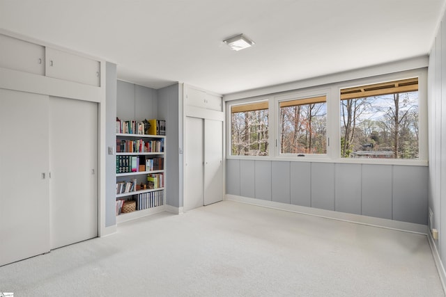carpeted spare room featuring plenty of natural light