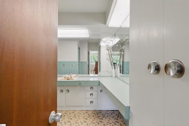 bathroom with tile patterned floors and vanity