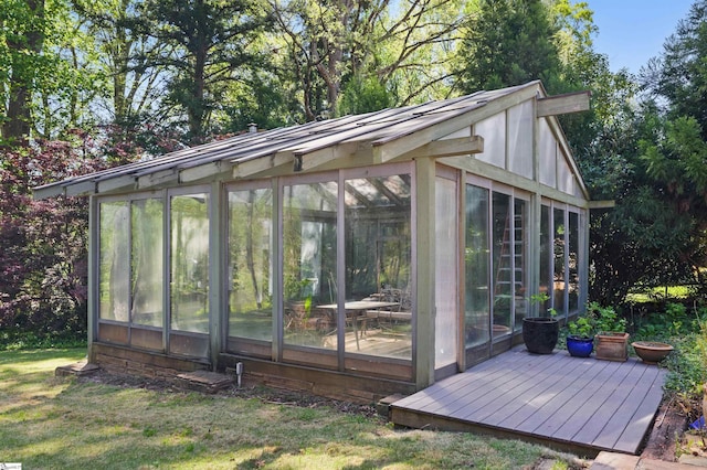 view of outdoor structure featuring a sunroom