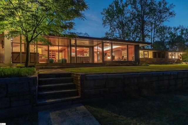 back of property featuring a yard