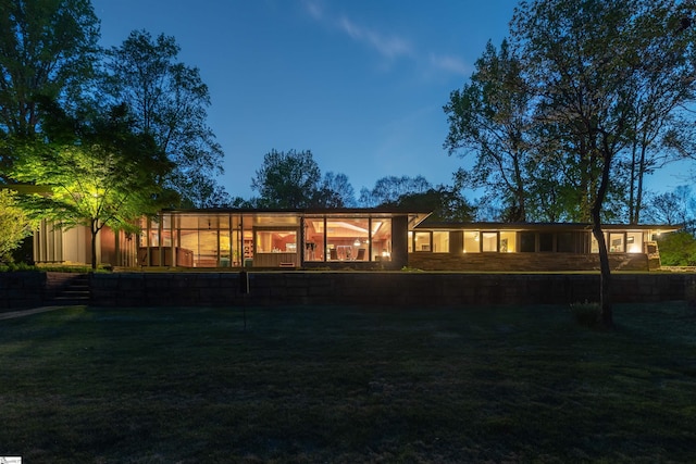back of property featuring a lawn