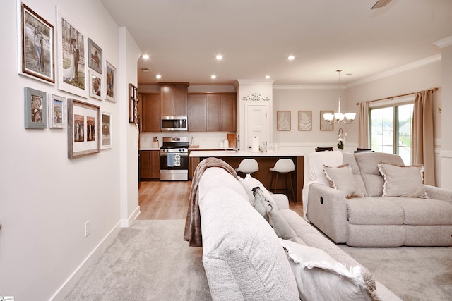 living room with crown molding, light colored carpet, recessed lighting, a chandelier, and baseboards