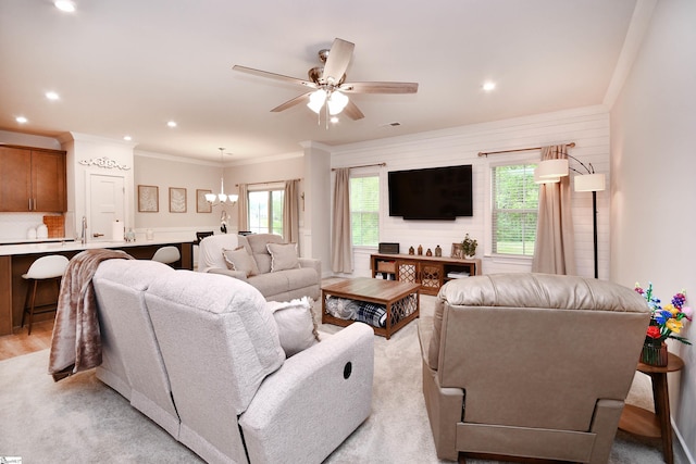 living room with crown molding, visible vents, recessed lighting, and ceiling fan with notable chandelier