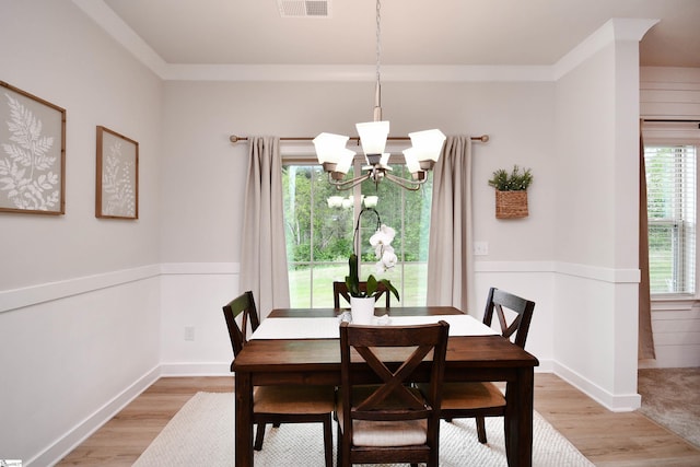dining room with visible vents, a chandelier, and light wood-style floors
