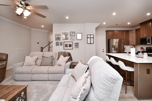 living room with ceiling fan, ornamental molding, and recessed lighting