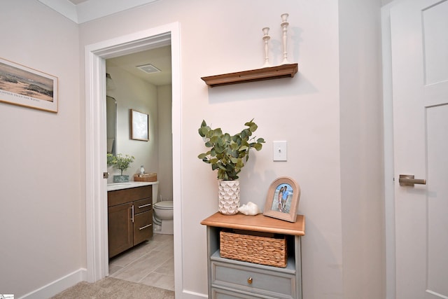corridor featuring visible vents and baseboards