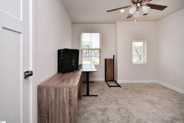 office area featuring carpet floors, a ceiling fan, plenty of natural light, and visible vents