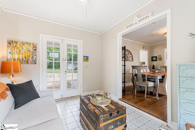 living room with light tile patterned floors, french doors, baseboards, and crown molding