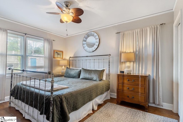 bedroom featuring wood finished floors, ceiling fan, baseboards, and ornamental molding
