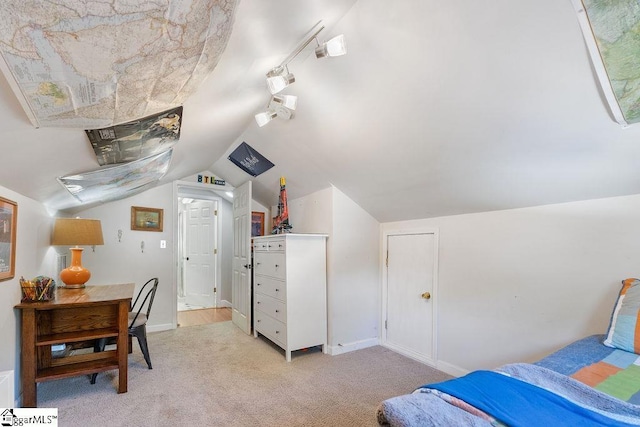 bedroom featuring light colored carpet, baseboards, and vaulted ceiling