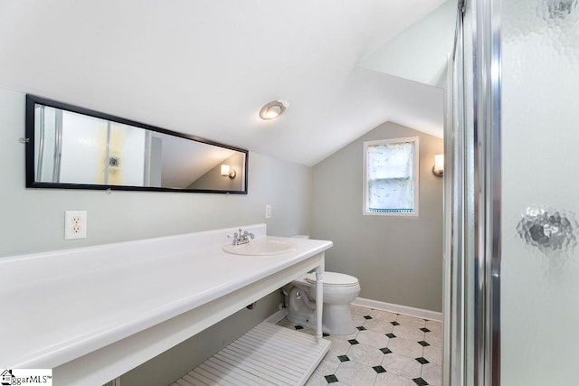 bathroom featuring vanity, baseboards, vaulted ceiling, and toilet