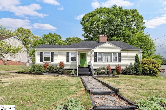 view of front of house featuring a front yard and a chimney