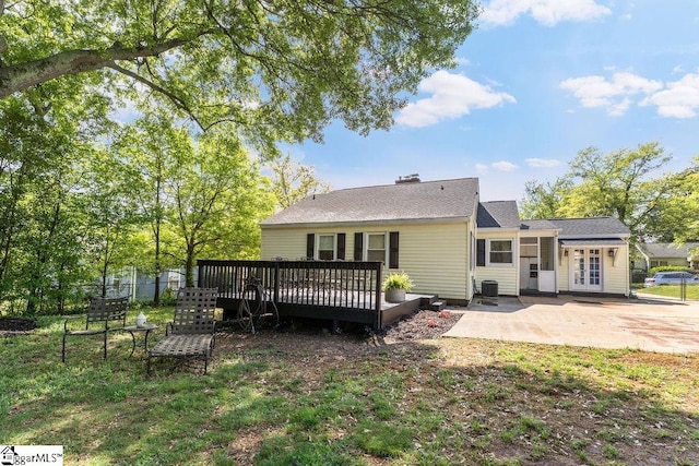 rear view of house featuring french doors, a patio area, central AC unit, a wooden deck, and fence