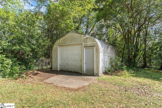 view of outbuilding with an outdoor structure and fence
