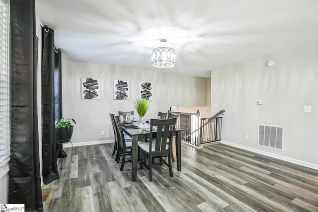302 Pamela Ln, Laurens, SC 29360 - dining area with a chandelier, wood finished floors, baseboards, and visible vents