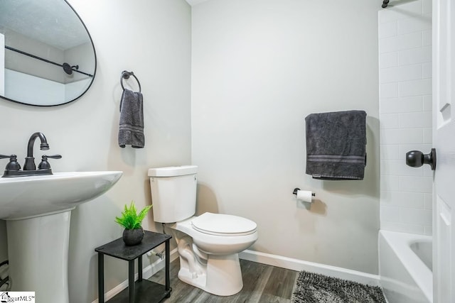 302 Pamela Ln, Laurens, SC 29360 - bathroom with baseboards, shower / tub combination, toilet, a sink, and wood finished floors