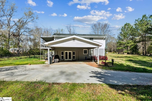 302 Pamela Ln, Laurens, SC 29360 - rear view of house featuring french doors, a lawn, and concrete driveway