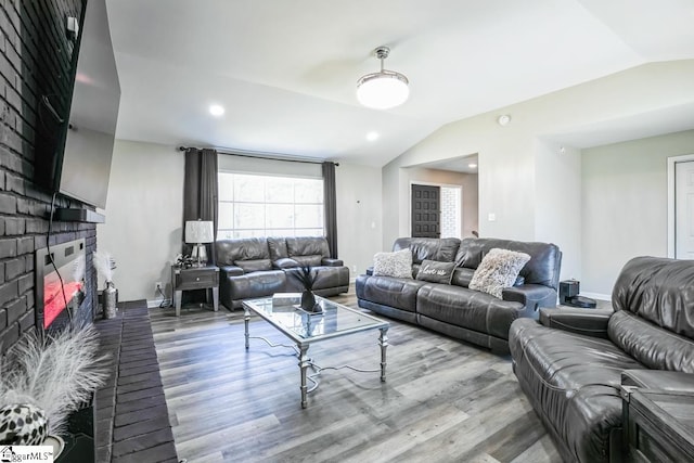 302 Pamela Ln, Laurens, SC 29360 - living room featuring baseboards, lofted ceiling, wood finished floors, and a fireplace