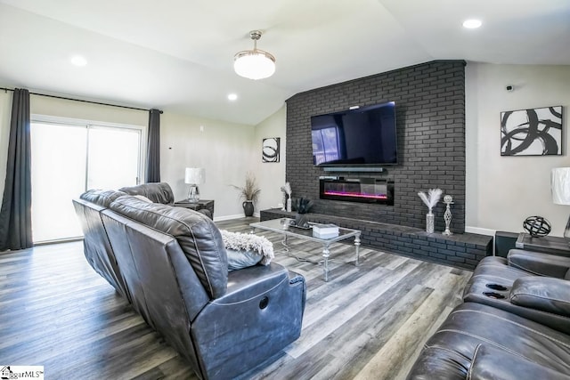 302 Pamela Ln, Laurens, SC 29360 - living room featuring a brick fireplace, baseboards, vaulted ceiling, and wood finished floors