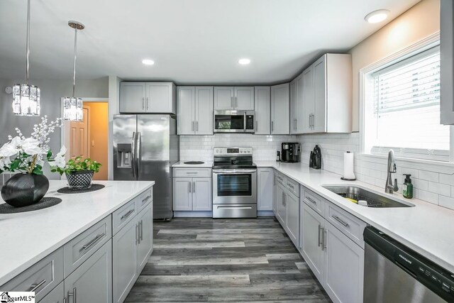 302 Pamela Ln, Laurens, SC 29360 - kitchen featuring stainless steel appliances, light countertops, a sink, and decorative backsplash