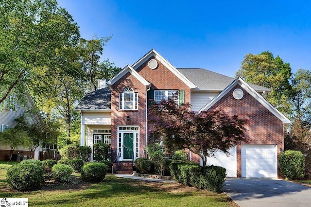 view of front facade with a chimney, driveway, and brick siding