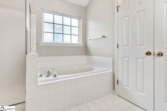 bathroom featuring a garden tub and tile patterned flooring
