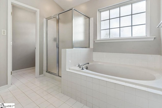 bathroom with tile patterned floors, a shower stall, and a garden tub