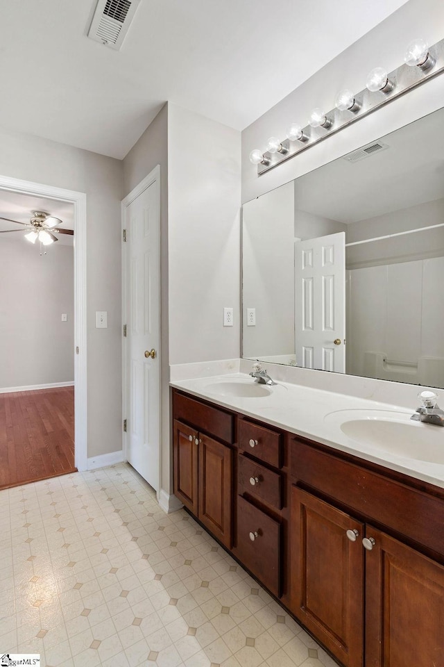 bathroom with a sink, visible vents, and double vanity