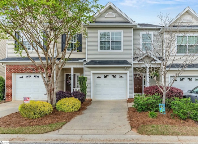 view of property featuring an attached garage and driveway