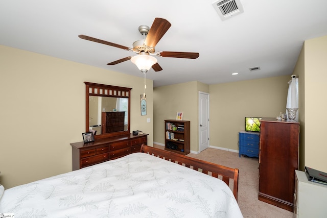 carpeted bedroom with ceiling fan, baseboards, and visible vents