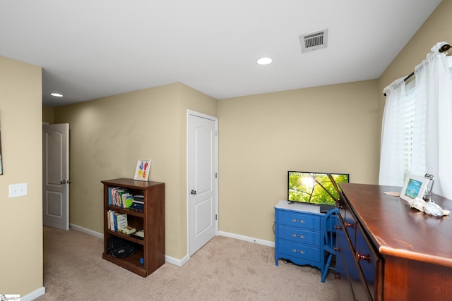 office area with light carpet, visible vents, and baseboards