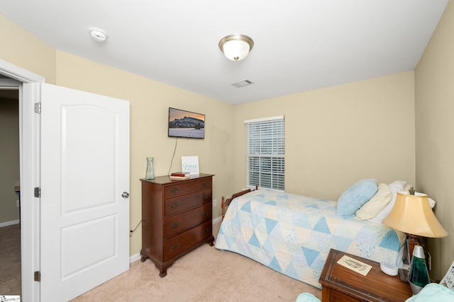 bedroom featuring visible vents, light colored carpet, and baseboards