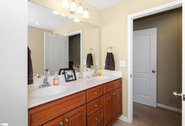 bathroom with a sink, baseboards, and double vanity