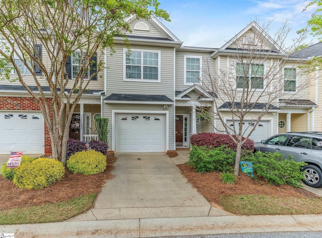 multi unit property with an attached garage and driveway