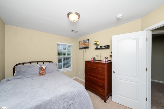 bedroom with visible vents, light colored carpet, and baseboards