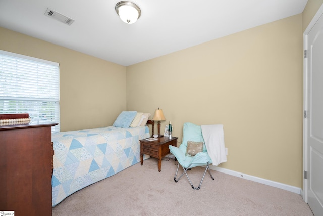 carpeted bedroom with baseboards and visible vents