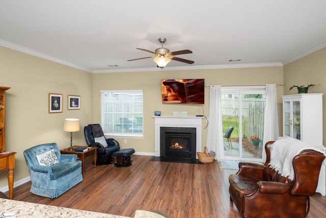 living room with ornamental molding, visible vents, wood finished floors, and a fireplace with flush hearth