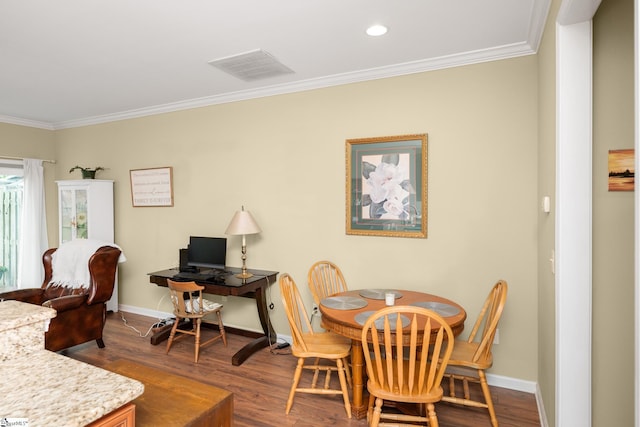 dining room with crown molding, visible vents, baseboards, and dark wood-style floors