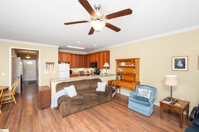 living room featuring ornamental molding, a ceiling fan, and wood finished floors