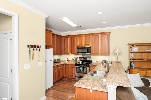 kitchen with crown molding, a kitchen breakfast bar, a peninsula, a sink, and stainless steel appliances
