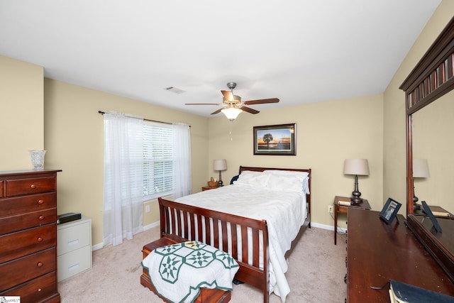 bedroom featuring light colored carpet, baseboards, a ceiling fan, and visible vents